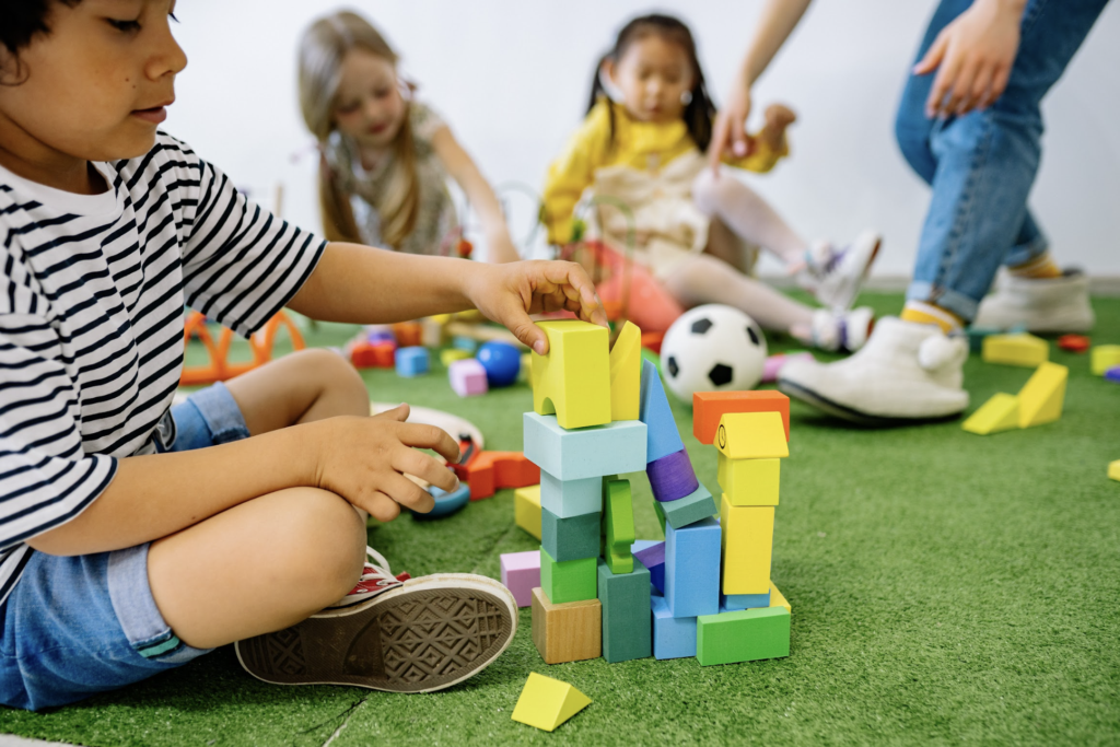 A colorful assortment of sensory toys designed for children with sensory processing challenges, including textured balls, chewable necklaces, and fidget tools.